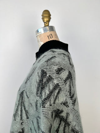 Green-grey knitted poncho with high collar and black jacquard (TU)