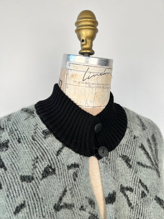 Green-grey knitted poncho with high collar and black jacquard (TU)