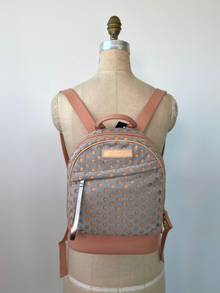 Grey and pink backpacks with perforated polka dots