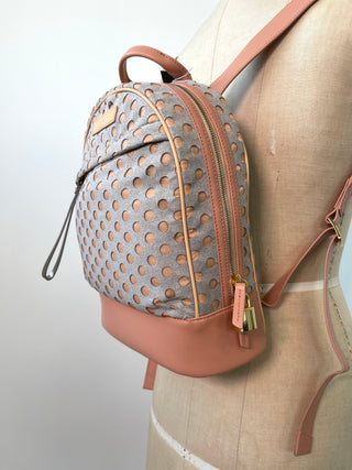 Grey and pink backpacks with perforated polka dots