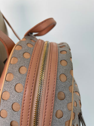 Grey and pink backpacks with perforated polka dots